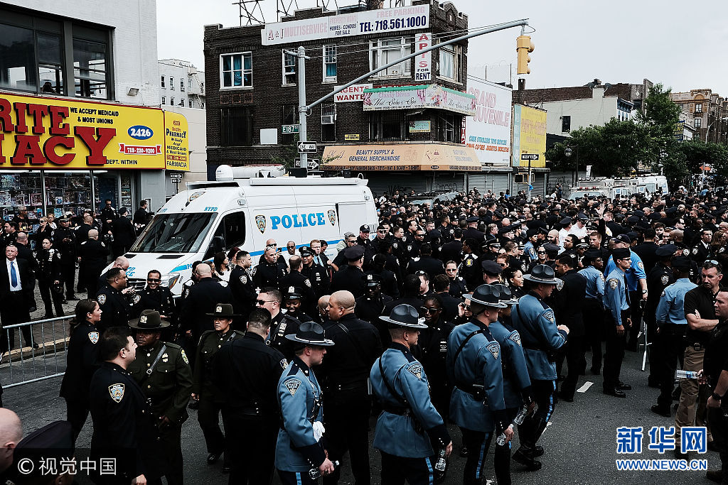 当地时间2017年7月11日，美国纽约，纽约女警察米索蒂斯·佛米利亚的葬礼举行。纽约市48岁女性警察米索蒂斯·佛米利亚(Miosotis Familia)5日凌晨在警车内遭歹徒枪击，头部中弹，送医后不治身亡。***_***NEW YORK, NY - JULY 11:  Thousands of police officers stand outside of a Bronx church during the funeral for NYPD Officer Miosotis Familia, who was shot and killed last week in what police have called 'an unprovoked attack' in the Bronx on July 11, 2017 in New York City. Thousands of police officers from around the country have joined local politicians and community leaders for the funeral of Officer Familia, 48, who was shot last Wednesday as she sat in an NYPD mobile command vehicle at 183rd St. and Creston Ave. in Fordham Heights.  (Photo by Spencer Platt/Getty Images)